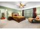 Spacious main bedroom featuring a ceiling fan, large window, and chaise lounge at 6005 Coral Berry Rd, Hanahan, SC 29410
