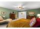 Green primary bedroom featuring a king bed, chaise lounge, and matching wooden dressers at 6005 Coral Berry Rd, Hanahan, SC 29410