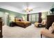 Spacious primary bedroom suite with sitting area, ceiling fan, and natural light at 6005 Coral Berry Rd, Hanahan, SC 29410
