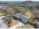 Aerial view of home showcasing lush landscaping, attached garage, and a long driveway at 689 Port Cir, Charleston, SC 29412