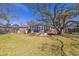 Expansive backyard featuring a deck, mature trees, and lush green grass at 689 Port Cir, Charleston, SC 29412