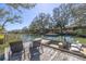 Backyard dock with chairs, boat, and waterfront views of the canal and neighborhood at 689 Port Cir, Charleston, SC 29412