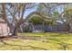 Beautiful backyard with lush greenery, mature trees, swing, and shaded seating areas at 689 Port Cir, Charleston, SC 29412