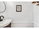 Modern bathroom includes a black vanity, round mirror, framed artwork, and matte fixtures at 689 Port Cir, Charleston, SC 29412