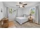 Inviting bedroom with lots of natural light, wood floors, and a comfortable bed with stylish side table and lamps at 689 Port Cir, Charleston, SC 29412
