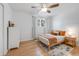 Cozy bedroom featuring hardwood floors, light walls, and a comfortable bed with bright pillows and a wood bedside table at 689 Port Cir, Charleston, SC 29412