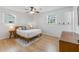 Well-lit bedroom showcasing hardwood floors, neutral decor, and a comfortable bed with stylish bedside tables and lamps at 689 Port Cir, Charleston, SC 29412