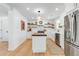 Modern kitchen with white cabinetry, butcher block island, stainless appliances, and light wood floors at 689 Port Cir, Charleston, SC 29412