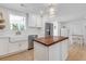 An airy kitchen shows an island with wood countertop, farmhouse sink, and stainless steel appliances at 689 Port Cir, Charleston, SC 29412