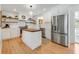 Bright, modern kitchen featuring white cabinetry, butcher block island, and stainless steel appliances at 689 Port Cir, Charleston, SC 29412