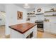 Kitchen featuring a wood-topped island, stainless appliances, gas cooktop, and white cabinetry and subway tile backsplash at 689 Port Cir, Charleston, SC 29412