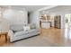 Open-concept living room with hardwood floors flowing into a bright, white kitchen at 689 Port Cir, Charleston, SC 29412