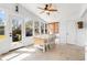 Bright sunroom featuring a dining table, sun-filled windows, and access to the outdoor patio at 689 Port Cir, Charleston, SC 29412