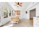 Sunroom with tiled floors, a ceiling fan, and a dining table set in front of sun-drenched windows at 689 Port Cir, Charleston, SC 29412