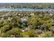 Aerial view of waterfront homes with docks, surrounded by lush trees and a bay at 7 Guerard Rd, Charleston, SC 29407