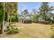 Spacious backyard with well-manicured lawn, a detached structure, and mature landscaping at 7 Guerard Rd, Charleston, SC 29407