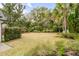 Expansive backyard with lush lawn, mature trees, and well-kept landscaping at 7 Guerard Rd, Charleston, SC 29407