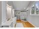 Bright bathroom with dual sinks, white cabinetry, and a glass enclosed shower at 7 Guerard Rd, Charleston, SC 29407