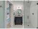 Bathroom with a marble-topped vanity, black hardware, and glass-enclosed shower with subway tile surround at 7 Guerard Rd, Charleston, SC 29407