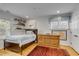 Bright bedroom featuring a wood bed frame, a light blue rug, and built-in shelving at 7 Guerard Rd, Charleston, SC 29407