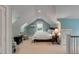 Bedroom with a bed, bedside tables, and two chairs in a room with an angled ceiling at 7 Guerard Rd, Charleston, SC 29407