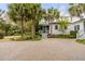 Home exterior features a screened porch, brick driveway, and well-maintained landscaping at 7 Guerard Rd, Charleston, SC 29407