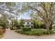 Beautiful home with a long brick driveway, mature trees, and manicured landscaping at 7 Guerard Rd, Charleston, SC 29407