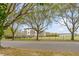 Brick building framed by large trees and a black fence along the street at 7 Guerard Rd, Charleston, SC 29407