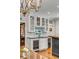 Kitchen wet bar featuring a wine cooler, glass door cabinets, granite countertops, and stylish fixtures at 7 Guerard Rd, Charleston, SC 29407