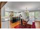 Bright kitchen boasts stainless steel appliances, a center island, and an adjacent dining area with doors to the outside at 7 Guerard Rd, Charleston, SC 29407