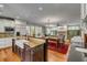 Gourmet kitchen featuring granite countertops, a center island with seating, and an open view to the living room at 7 Guerard Rd, Charleston, SC 29407