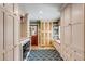 Well-organized laundry room with ample storage cabinets, a folding counter, and a modern washer and dryer at 7 Guerard Rd, Charleston, SC 29407
