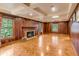 Spacious living room featuring wood-paneled walls, a brick fireplace, and parquet floors at 7 Guerard Rd, Charleston, SC 29407
