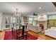 Open-concept living room with dining area, fireplace, and access to outdoor patio at 7 Guerard Rd, Charleston, SC 29407