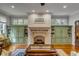 Inviting living room features a stone fireplace flanked by built-in bookshelves and a decorative coffee table at 7 Guerard Rd, Charleston, SC 29407