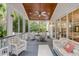 Relaxing screened porch featuring comfortable wicker seating, ceiling fan, and serene outdoor views at 7 Guerard Rd, Charleston, SC 29407