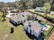 Sprawling estate featuring a luxurious home with a pool, spa, outdoor seating, and lush landscaping from an aerial perspective at 7858 Gull Bay Dr, Awendaw, SC 29429