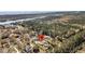 Stunning aerial view showcasing a waterfront home with lush landscaping and a sparkling pool, set in a serene environment at 7858 Gull Bay Dr, Awendaw, SC 29429