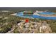 Beautiful aerial view showcasing a grand home with a circular driveway, surrounded by trees and a lake at 7858 Gull Bay Dr, Awendaw, SC 29429