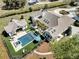 Stunning aerial view of home with pool, manicured lawns, and a circular driveway at 7858 Gull Bay Dr, Awendaw, SC 29429