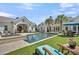 Stunning backyard showcasing the pool, pool house, and outdoor dining area at 7858 Gull Bay Dr, Awendaw, SC 29429