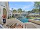 Inviting backyard featuring a sparkling pool, spa, and expansive patio with comfortable seating, ideal for outdoor living and entertaining at 7858 Gull Bay Dr, Awendaw, SC 29429