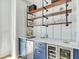 Stylish bar area with blue cabinets, wine storage, and open shelving for entertaining at 7858 Gull Bay Dr, Awendaw, SC 29429