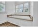 Elegant bathroom featuring a soaking tub with natural light from shuttered windows at 7858 Gull Bay Dr, Awendaw, SC 29429