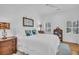 Inviting bedroom with a plush bed, complemented by stylish lamps and shuttered windows at 7858 Gull Bay Dr, Awendaw, SC 29429