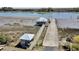 Aerial view of a private boat ramp, featuring a gazebo and dock, providing direct access to the scenic waterway at 7858 Gull Bay Dr, Awendaw, SC 29429