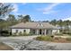 Lovely single-story home with an inviting circular driveway, mature landscaping, and a classic front porch at 7858 Gull Bay Dr, Awendaw, SC 29429