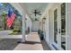 Charming front porch featuring a painted ceiling, ceiling fans, and elegant columns, enhancing the home's curb appeal at 7858 Gull Bay Dr, Awendaw, SC 29429