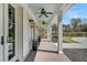 Inviting front porch with ceiling fans, classic columns, and charming outdoor decor, perfect for relaxing at 7858 Gull Bay Dr, Awendaw, SC 29429