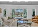 Inviting living room with comfortable seating and a view of the pool area at 7858 Gull Bay Dr, Awendaw, SC 29429